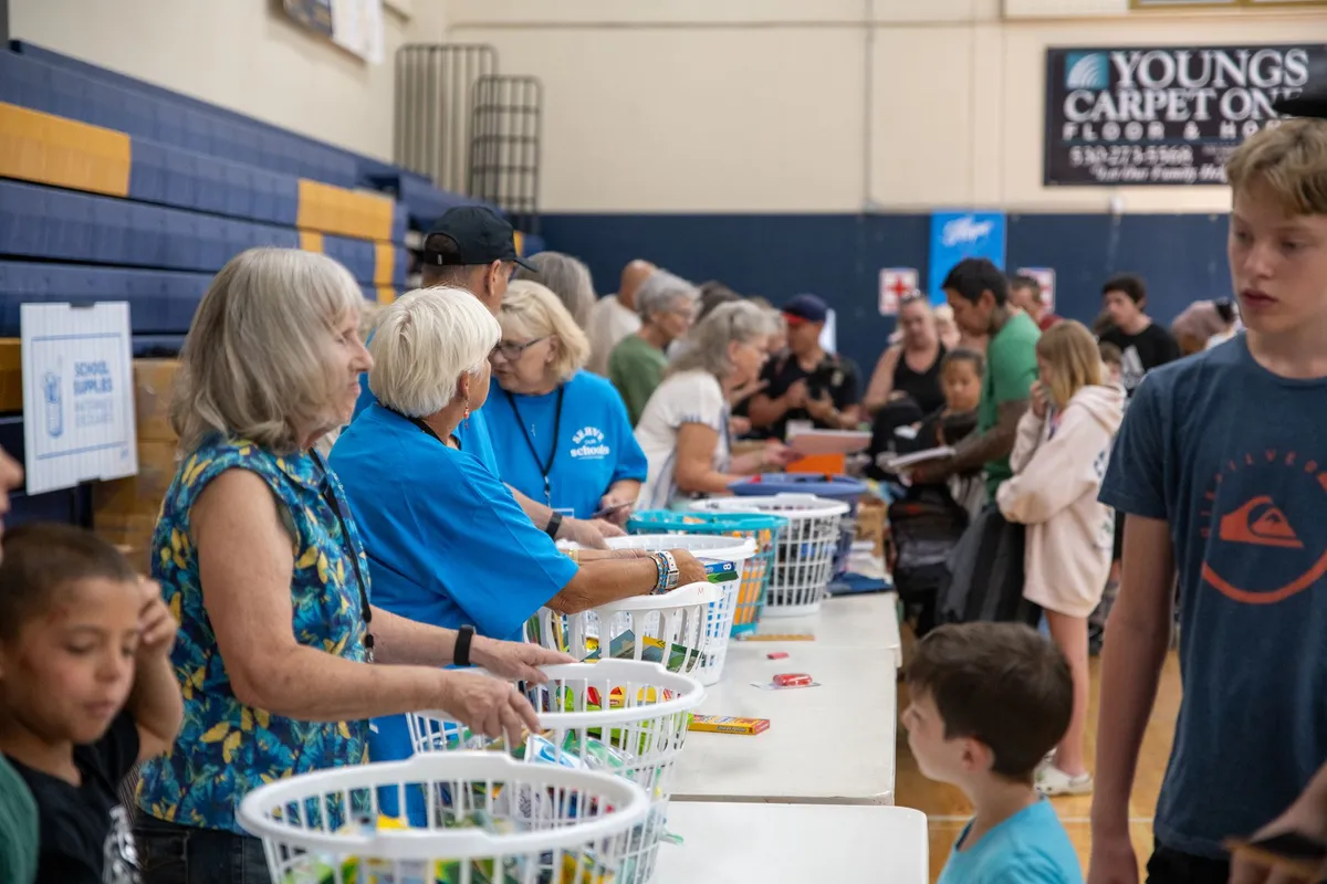 Volunteers helping children choose school supplies at a Hope for Nevada County event.